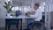 Online training, student disabled in wheelchair making notes in notebook during distant education sitting at table with