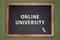 Online university written on chalkboard, green background