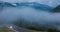 The onset of twilight in the mountains and the appearance of fog on a mountain serpentine, Evening mountain time lapse