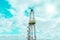 Onshore land rig in oil and gas industry. Oil drilling rig against a blue sky with clouds.