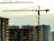 Ð¡onstruction site with tower cranes on building construction.