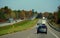 Ontario, Canada - October 28, 2019 - The view of the traffic on Route 401 highway overlooking the sunning colors of fall foliage