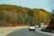 Ontario, Canada - October 28, 2019 - The view of the traffic on Route 401 highway overlooking the sunning colors of fall foliage