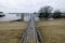 Ooden fisherman jetty with cloudy sky.