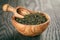 Oolong green tea in wood bowl on oak table