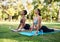 Ooo, I can definitely feel that. two attractive young women holding a yoga pose in the park during the day.