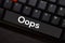 Oops isolated on laptop keyboard background