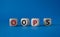 Oops symbol. Concept word Oops on wooden cubes. Beautiful blue background. Business and Oops concept. Copy space