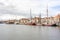 Oosterhaven quay in the city harbor, anchored boats, houses and buildings in the background