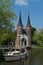 Oostpoort Delft against blue sky showing boat in canal