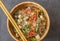 Op view of an oriental wooden plate with vegan dish of glass noodles