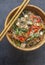 Op view of an oriental wooden plate with vegan dish of glass noodles