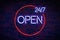 a we are open 24/7 hours neon sign on the wall, night life illuminated glow