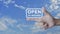 Open 24 hours icon on finger over blue sky with whie clouds, Business full time service concept