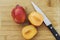 Open Amigo Pluot Next to a Whole Amigo Pluot with Knife