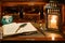 An open antique book in which a writing pen rests. are found on a wooden desk on leather. Two lighted lanterns are incorporated to