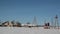 An open area with a warehouse is covered in snow