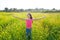 Open arms happy teen girl in spring meadow