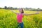 Open arms happy teen girl in spring meadow