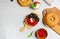 Open bagel with cream cheese, fresh cranberries and blueberries, on a wooden board. Overhead, copy of the space