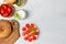 Open bagel sandwiches with cream cheese, sweet tomatoes and mixed salad. Top view, on a light wooden background. A copy