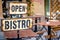 Open bistro sign at the empty caffe terrace