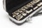 Open black case with a flute lying in it with large keys close-up