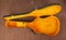 Open black and yellow acoustic guitar hard case on a wooden background