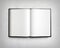 Open blank textbook on white stucco wall