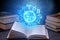 Open book on astrology on a dark background. Glowing magical globe with signs of the zodiac in the blue light
