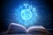 Open book on astrology on a dark background. Glowing magical globe with signs of the zodiac in the blue light