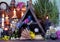 Open book with flowers, candles and magic bottles on witch table