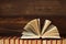 An open book lies on a stack of books on a wooden background