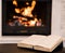 Open book lying near the fireplace
