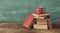 Open book, vintage hardback book and cup of coffee on green  background. Education, reading, research concept.Vintage analog film