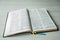 An open book on a wooden table. Bible on wooden background