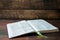 An open book on a wooden table. Bible on wooden background