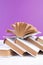 Open books, hardback colorful books on wooden table. purple background. Back to school. Copy space for text. Education business