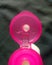 Open bottle cap. View of the pink plastic bottle cover from lotion packaging