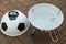 Open brazier in form of soccer ball stands in yard