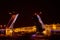 Open bridge over the river in the evening city. Drawbridge in Saint Petersburg with night lights