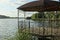 Open brown empty gazebo with wrought iron fence