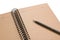 Open brown note book with lined and gray pen on white background