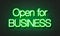 Open for business neon sign on brick wall background.