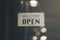 `Open` on cafe or restaurant hang on door at entrance