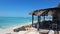 Open cafe on the sandy beach on the coast under the blue sky