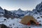 Open camping tent with kitchen stuff in snowy.