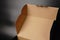 An open cardboard box on a black background. Dimmed lights