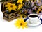 the open casket decorated yellow with flowers and coffee, isolate