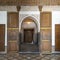 Open cedar wood painted doors for a stucco arched opening in the Bahia Palace in Marrakesh, Morocco.